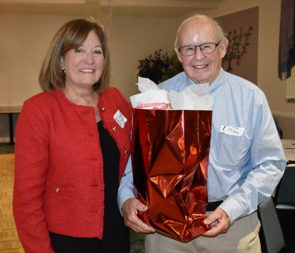 Photo of Kathy Scanlon presenting resignation gift to Jack O'leary