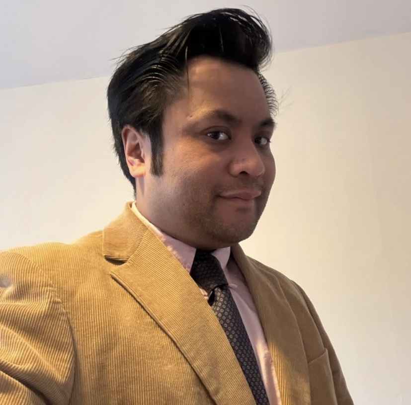 Photo of Ben Tan, in a yellow suit jacket